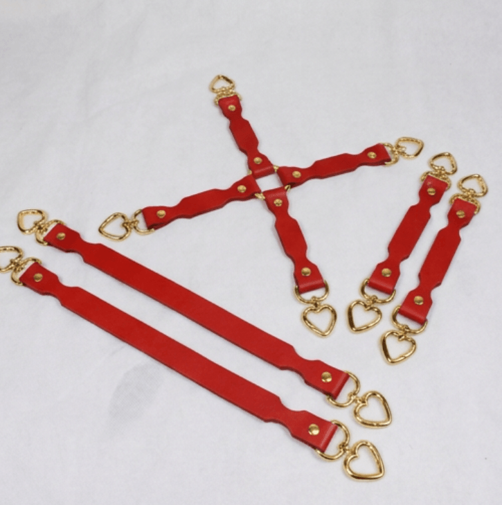 a collection of red leather straps with gold heart-shaped buckles, arranged in various orientations on a white background.