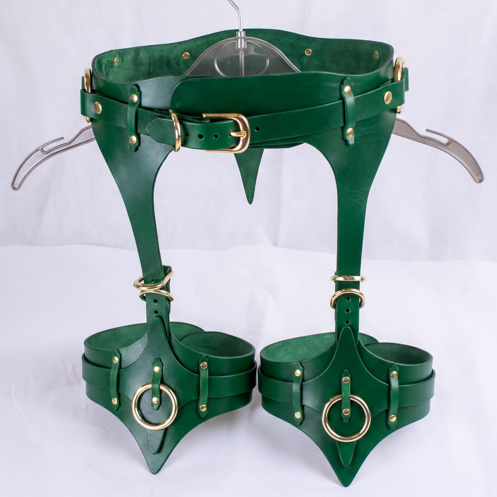 A pair of green leather thigh-high boots with a unique design and multiple buckles and straps.