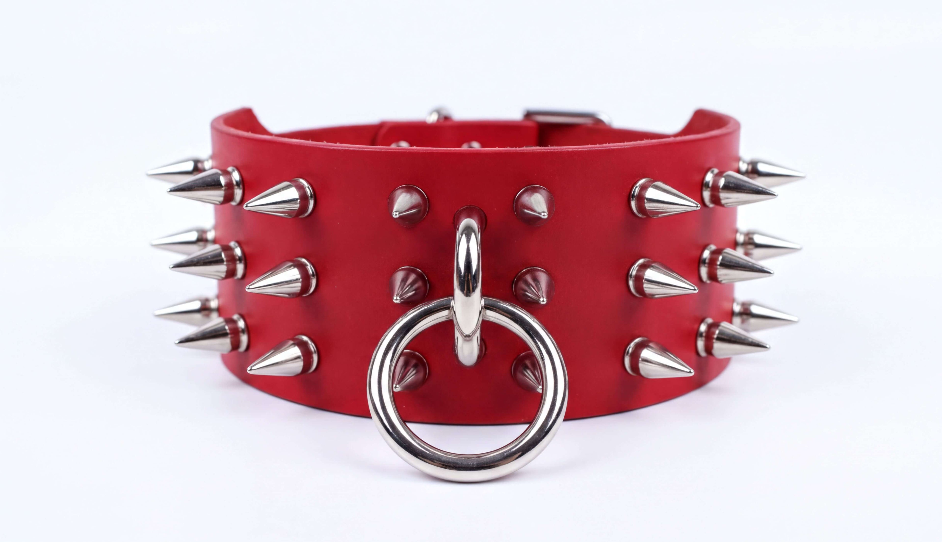 A red leather choker necklace with spikes protruding from it.