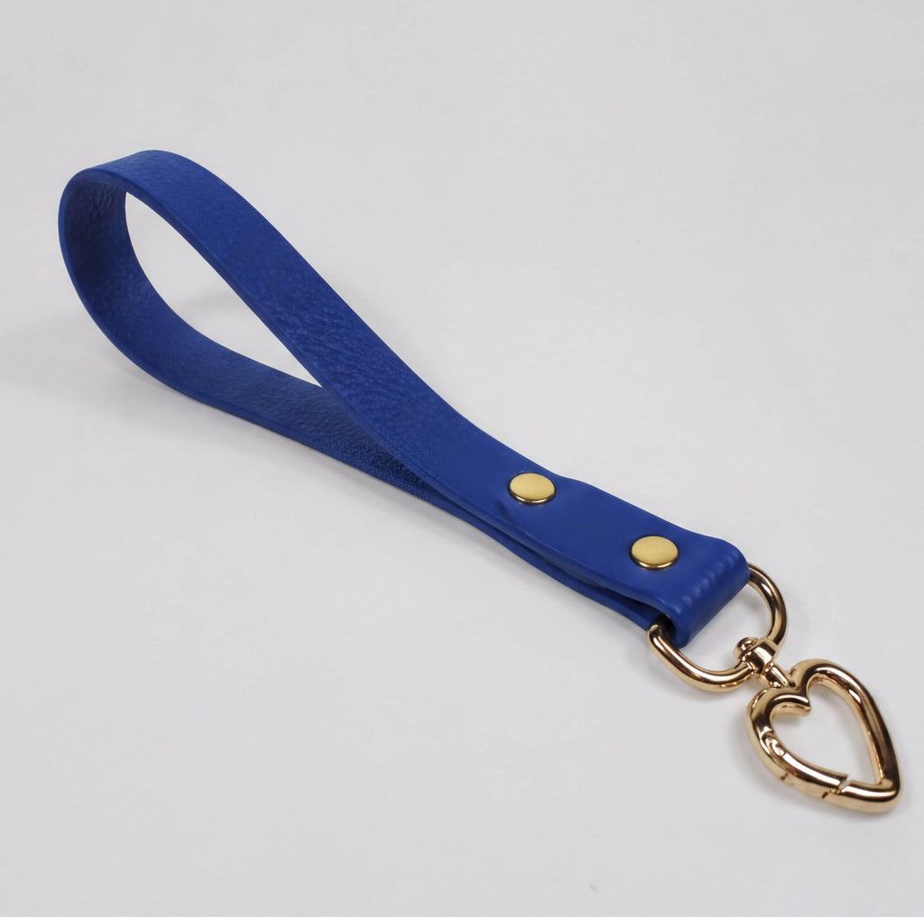 A blue leather strap with a heart-shaped metal clasp attached to it.