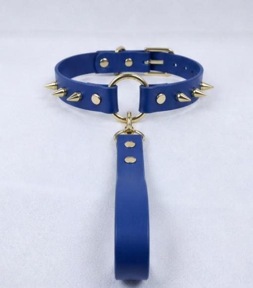 A blue spiked collar with gold studs and a gold-colored loop is displayed on a white surface.