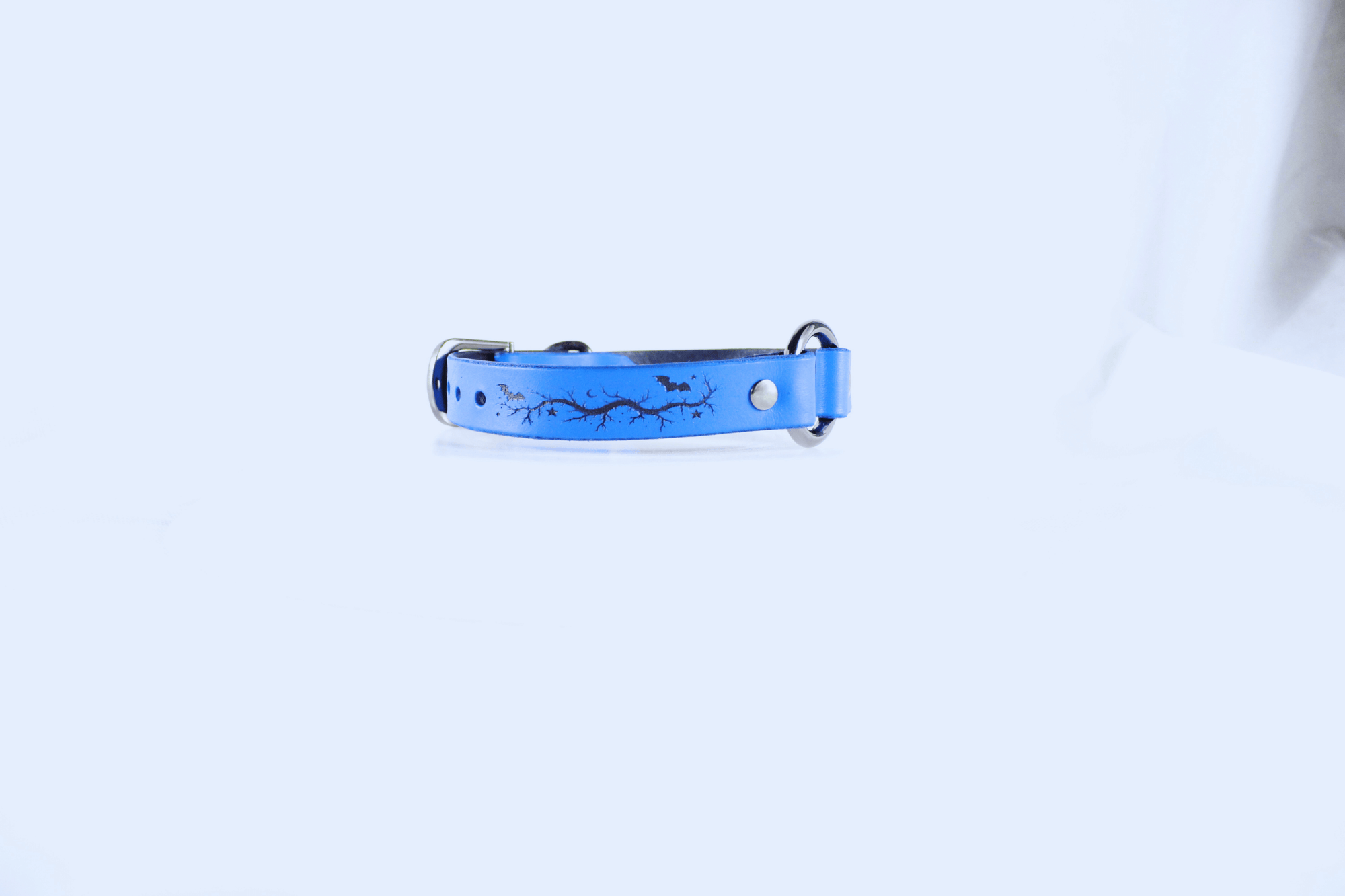 Submissive Collar Blue Moon & Bats Leather Choker featuring a blue design with bats and crescent moons.