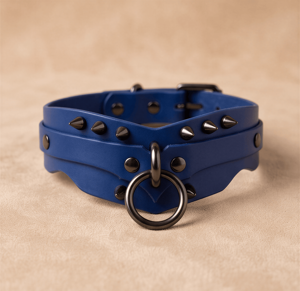 A blue leather choker necklace with spikes and a metal ring on the front.