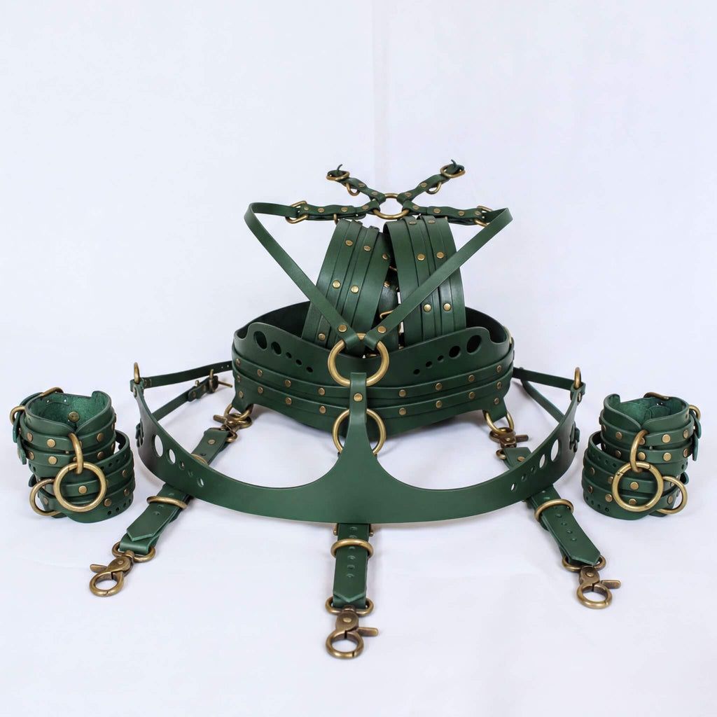 A set of green leather straps and buckles, likely used for BDSM or BDSM-related activities.