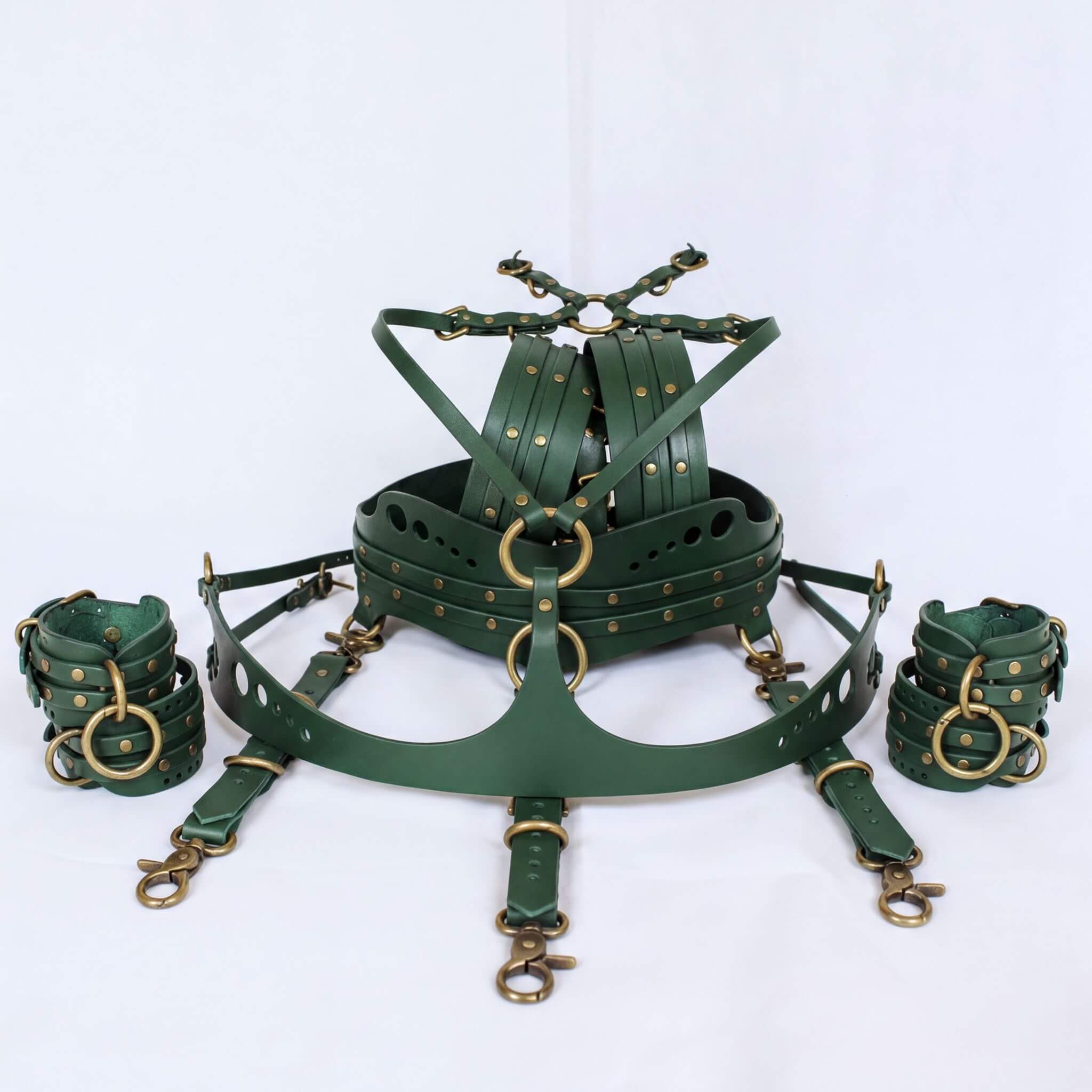 A set of green leather straps and buckles, likely used for BDSM or BDSM-related activities.
