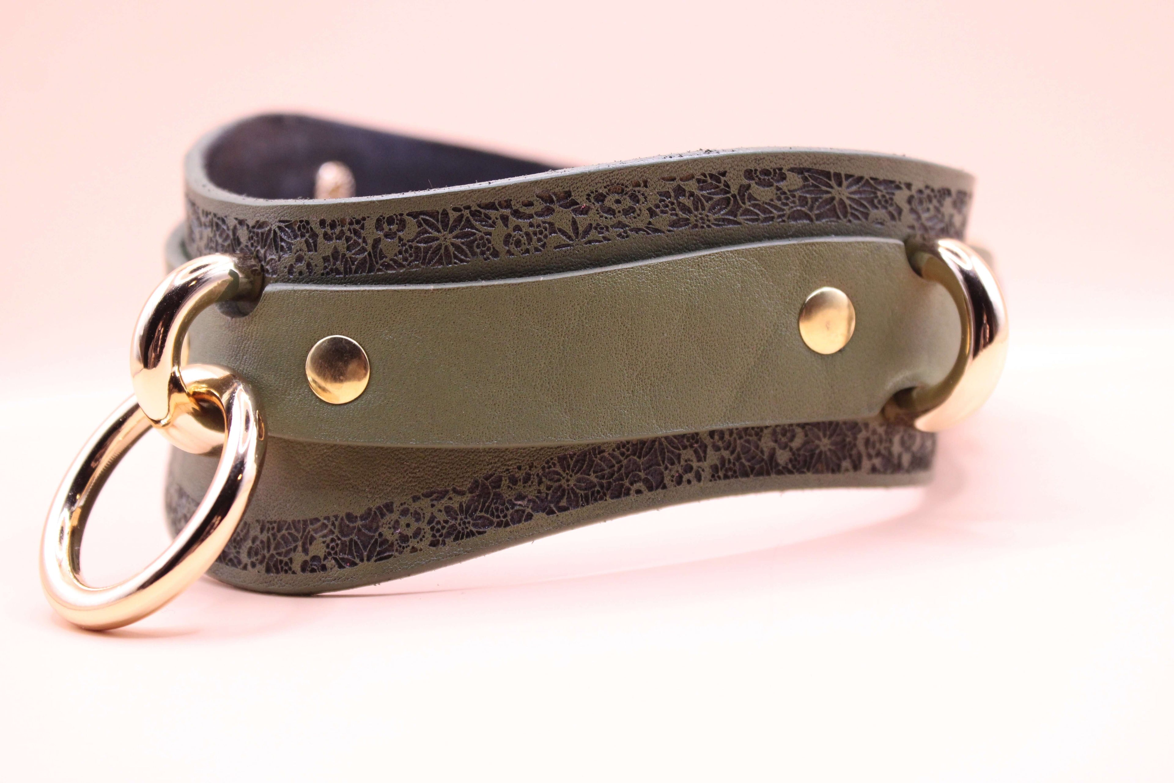 Avocado green leather choker with embossed design and metal rings for a stylish, discreet day collar.
