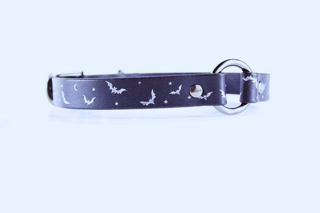 Bat and Moon Leather Choker featuring a sleek design with bat and moon motifs in silver on a black background.