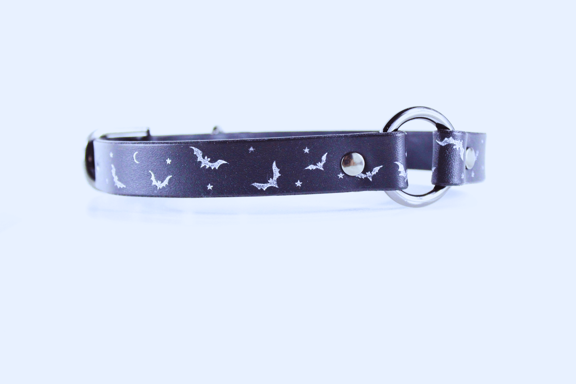 Bat and Moon Leather Choker featuring a sleek design with bat and moon motifs in silver on a black background.