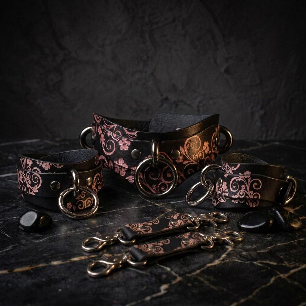 a collection of ornate leather straps and buckles, featuring intricate floral and scroll designs, arranged on a dark surface.