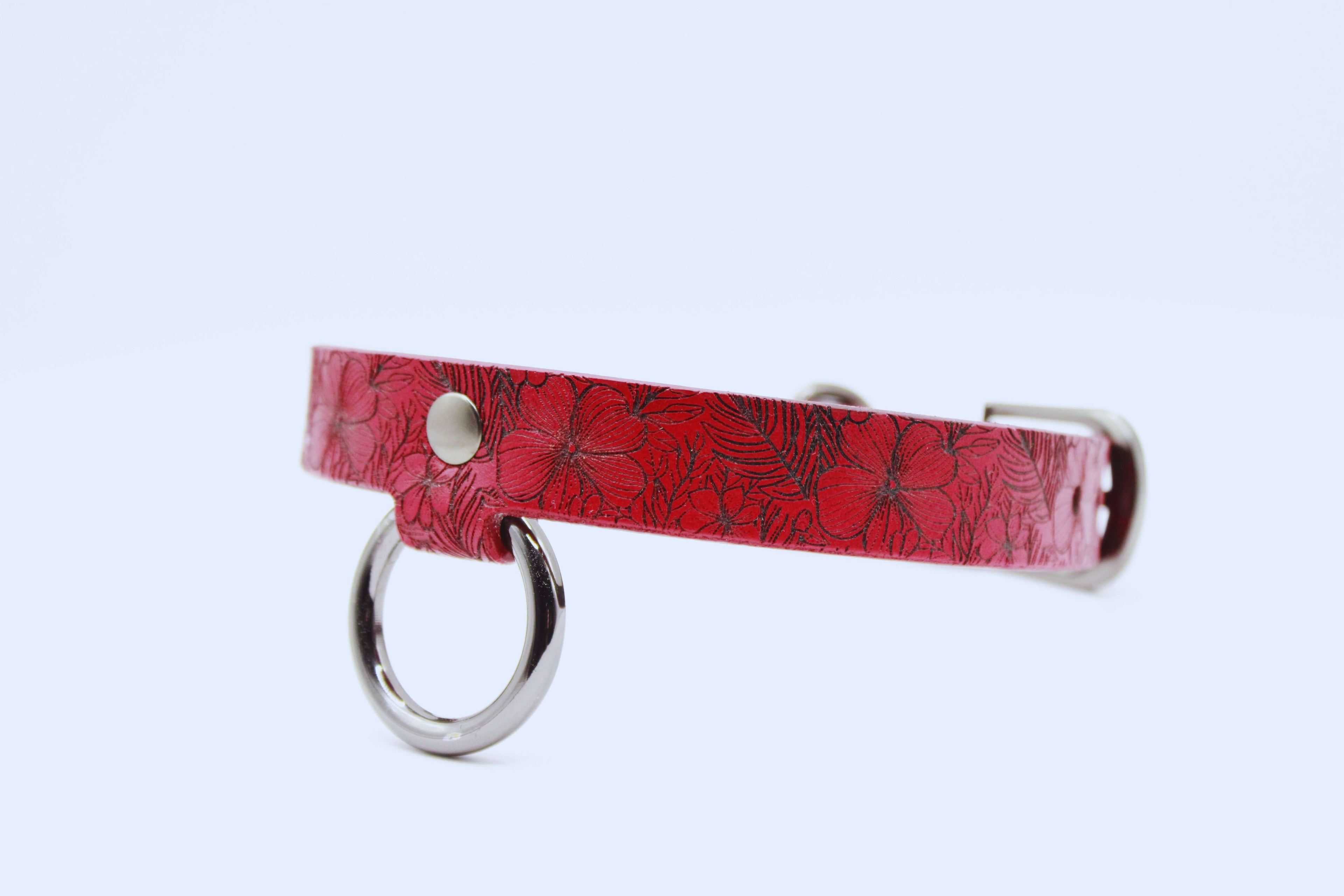 Red floral leather choker collar with silver accents, designed for elegance and intimacy.