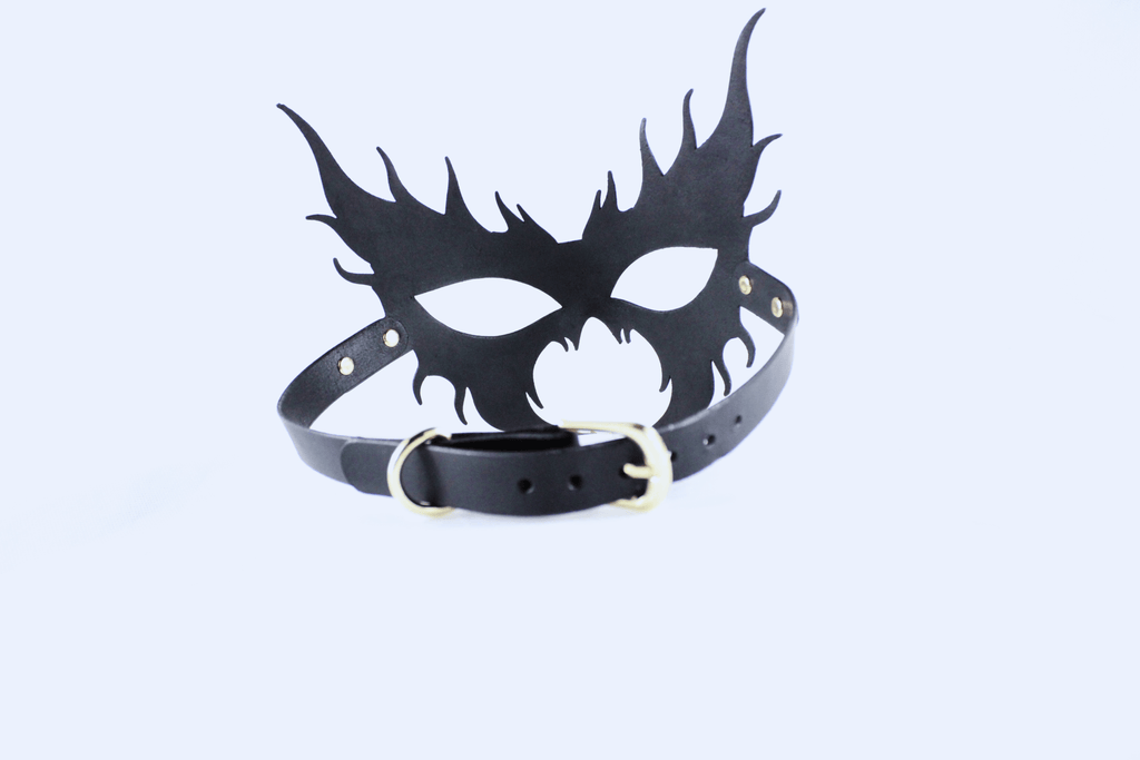 A black mask with sharp, pointed features and a black leather strap.