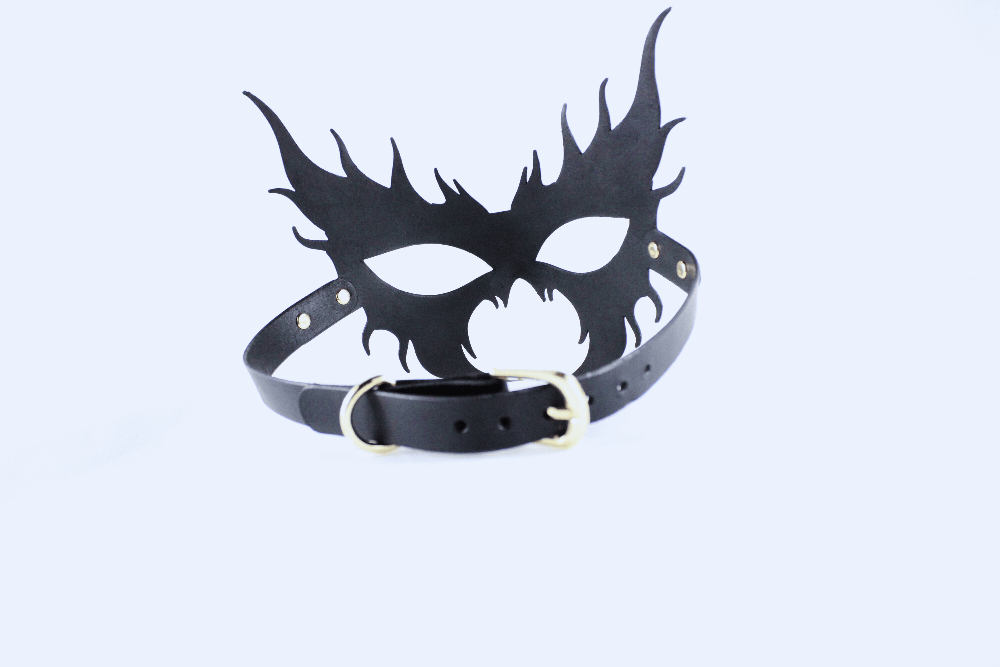 A black mask with sharp, pointed features and a black leather strap.