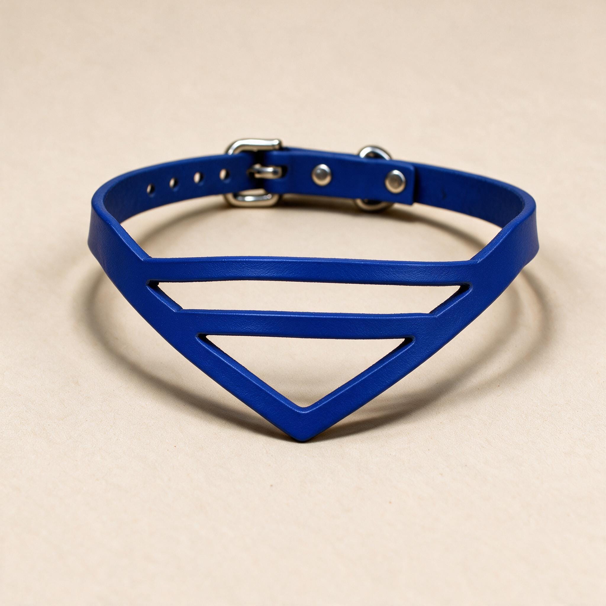 A blue choker necklace with a unique triangular cutout design.