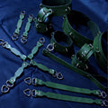 a collection of green leather straps and buckles arranged on a blue background.