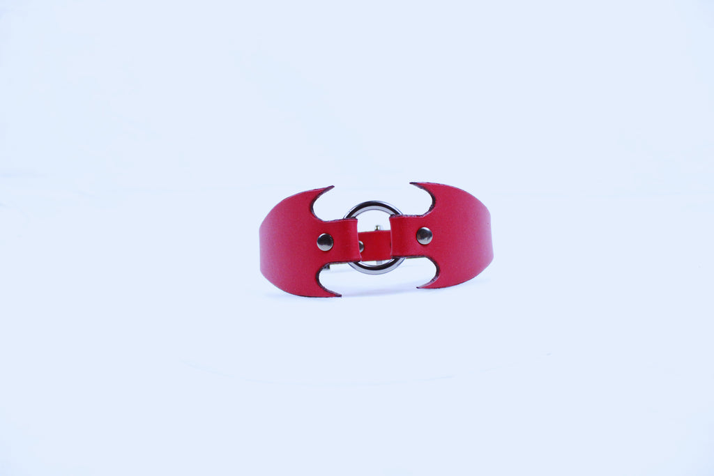 A red leather collar with a unique, bat-like design.