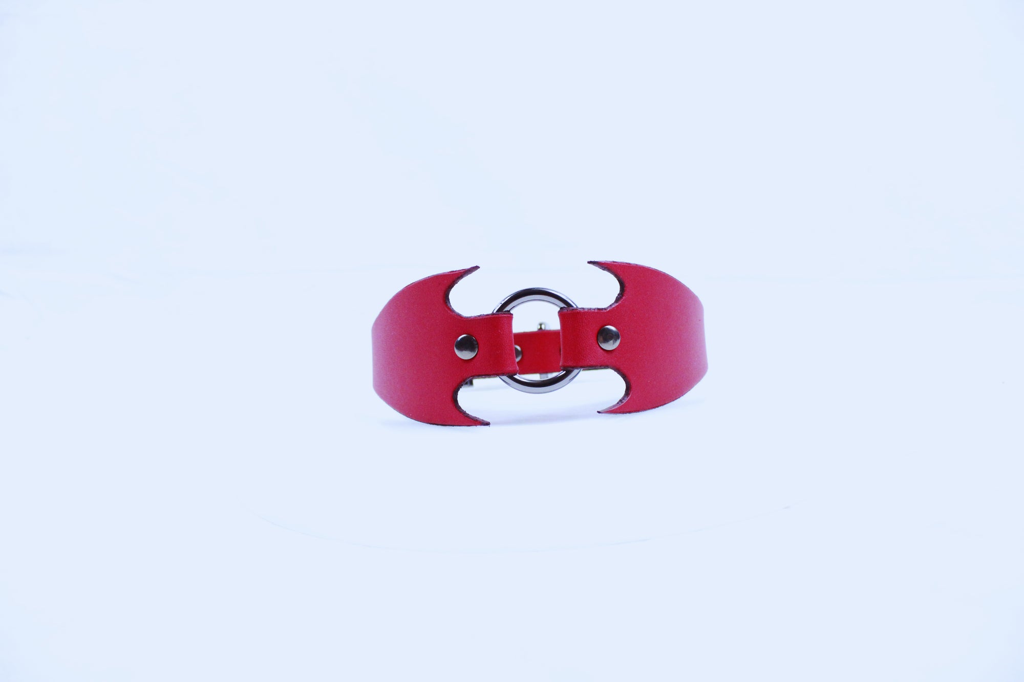 A red leather collar with a unique, bat-like design.