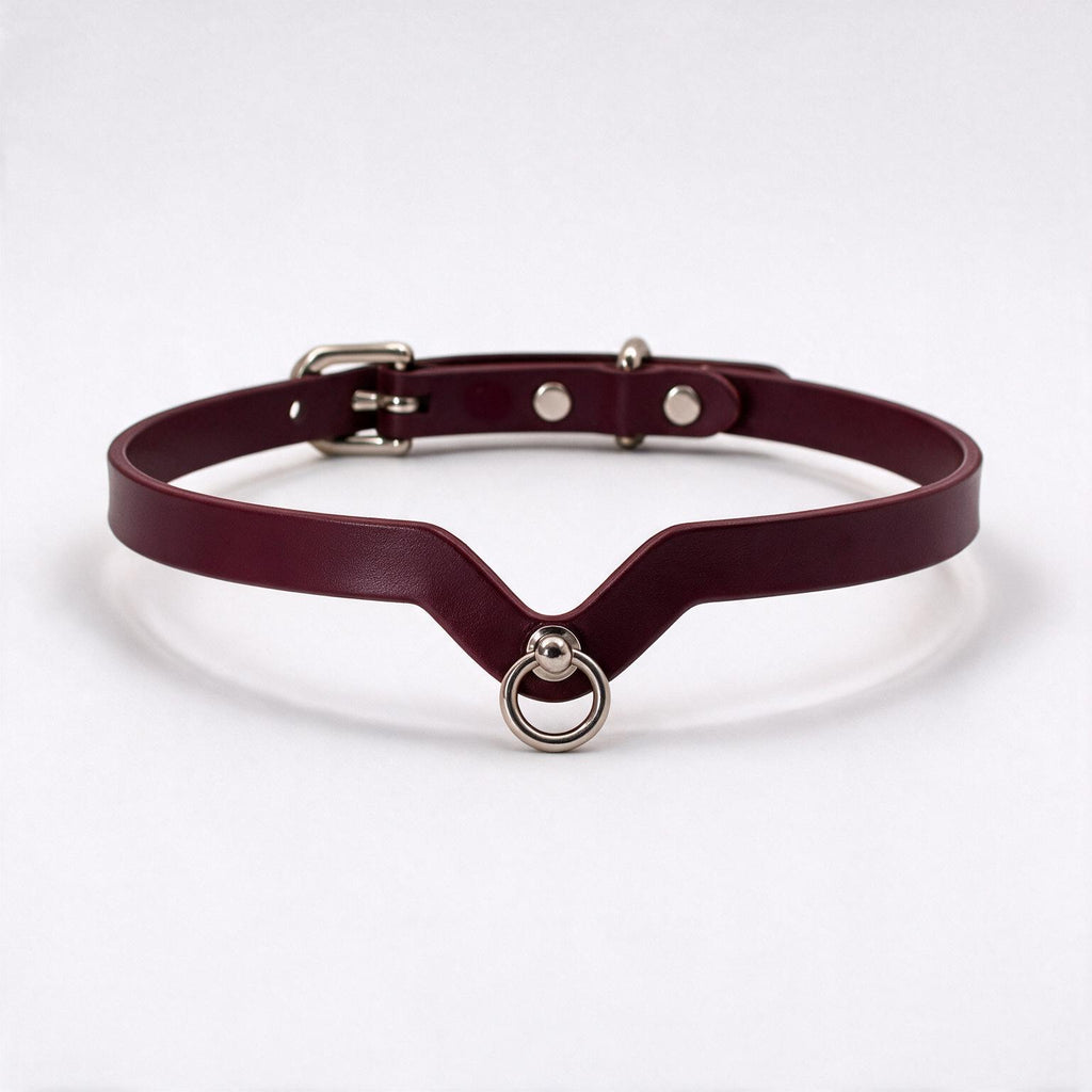 A burgundy leather choker necklace with a metal ring and buckle.
