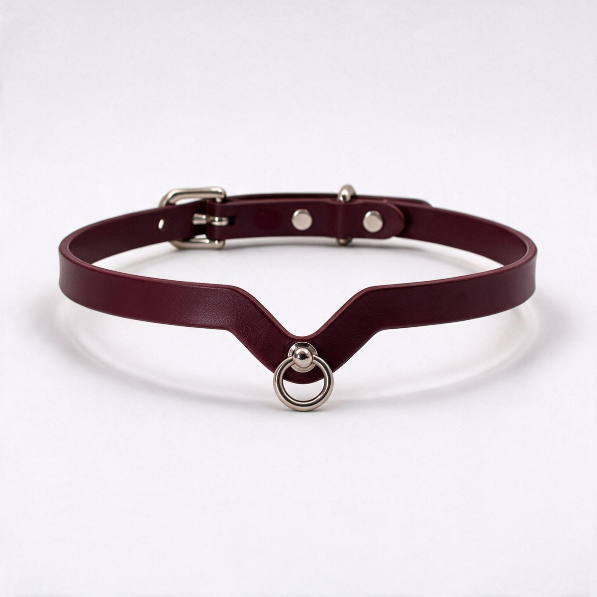 A burgundy leather choker necklace with a metal ring and buckle.