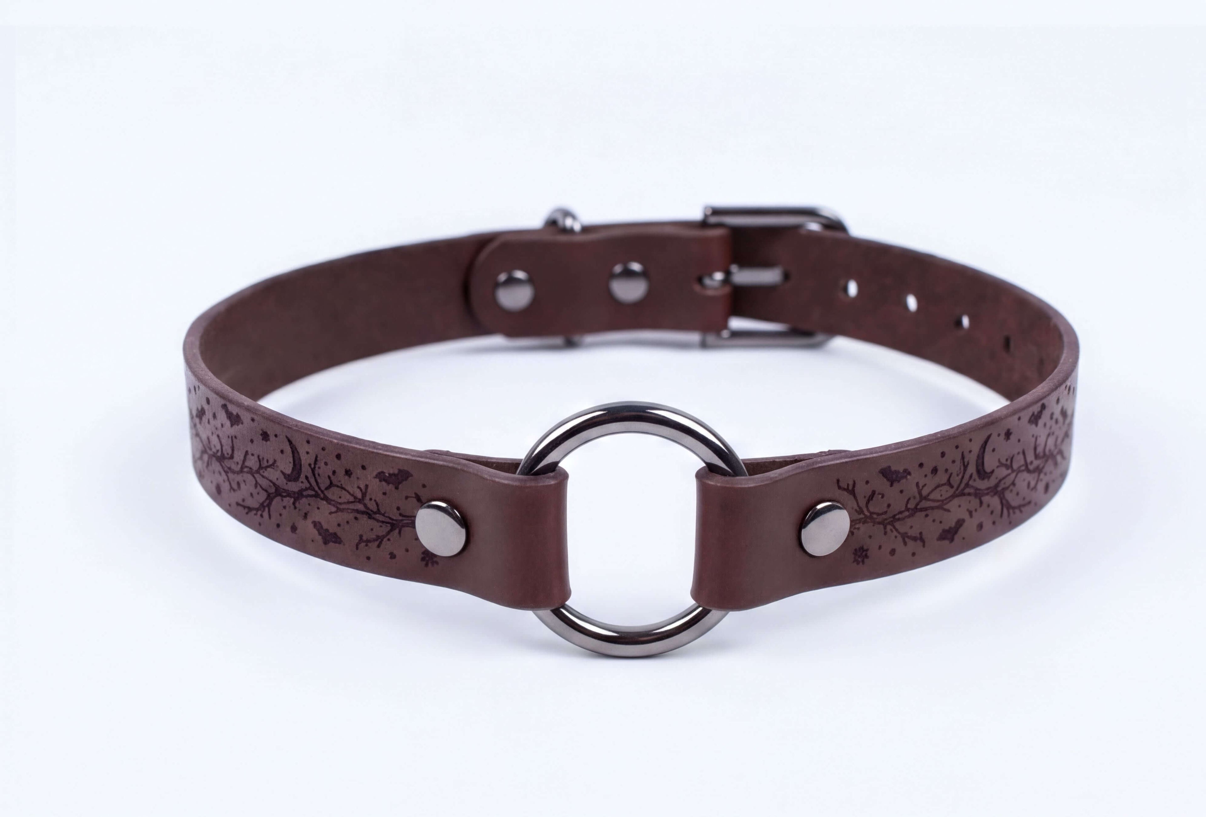 A brown leather choker collar with a metal ring and buckle.