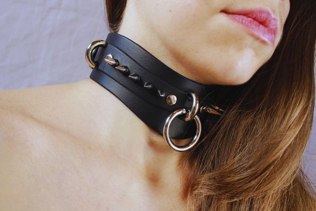 Close-up of Obsidian BDSM Collar featuring dual stainless-steel rings on a matte black leather choker.