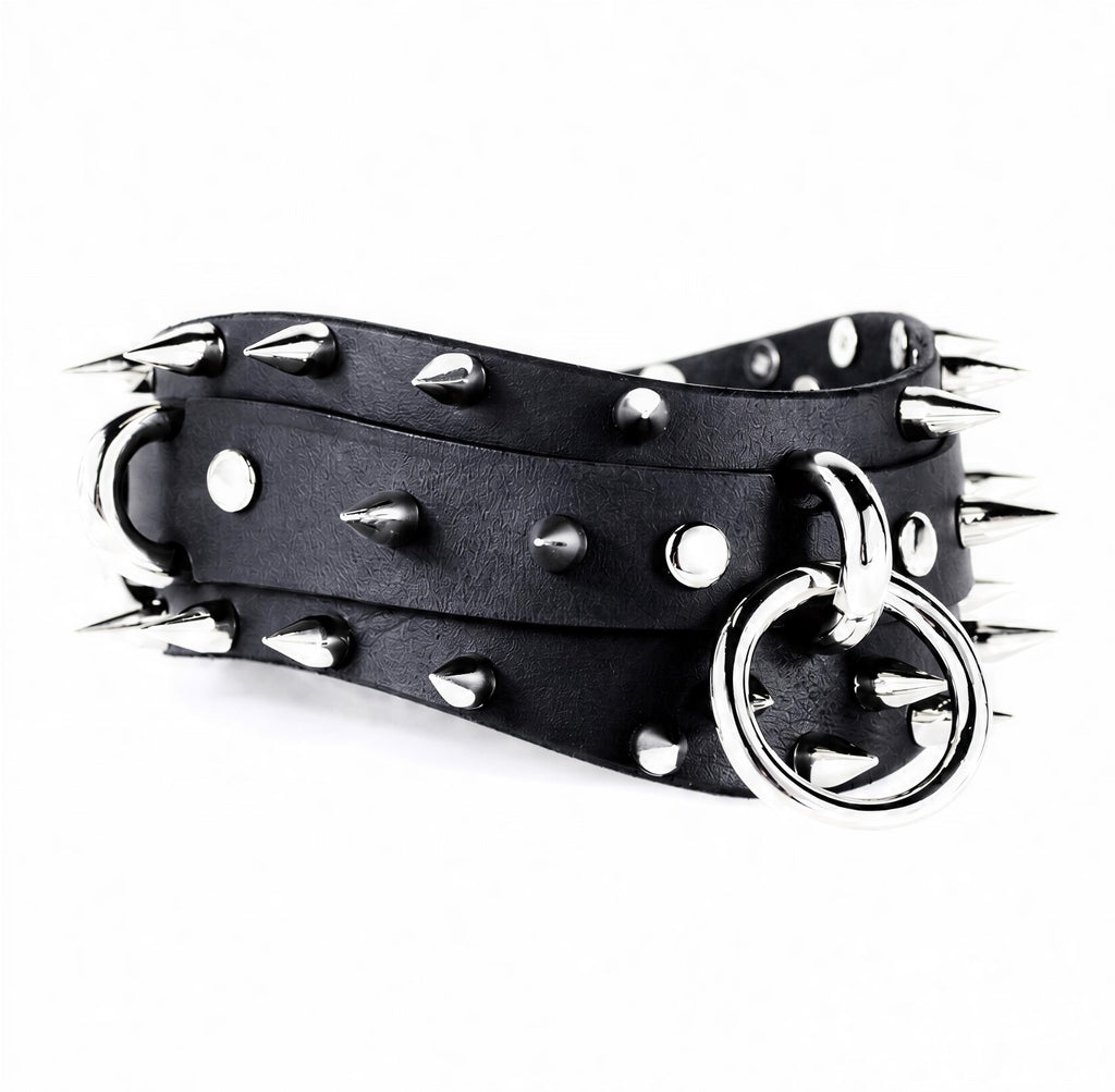 A black leather belt with silver spikes and a metal ring on it.