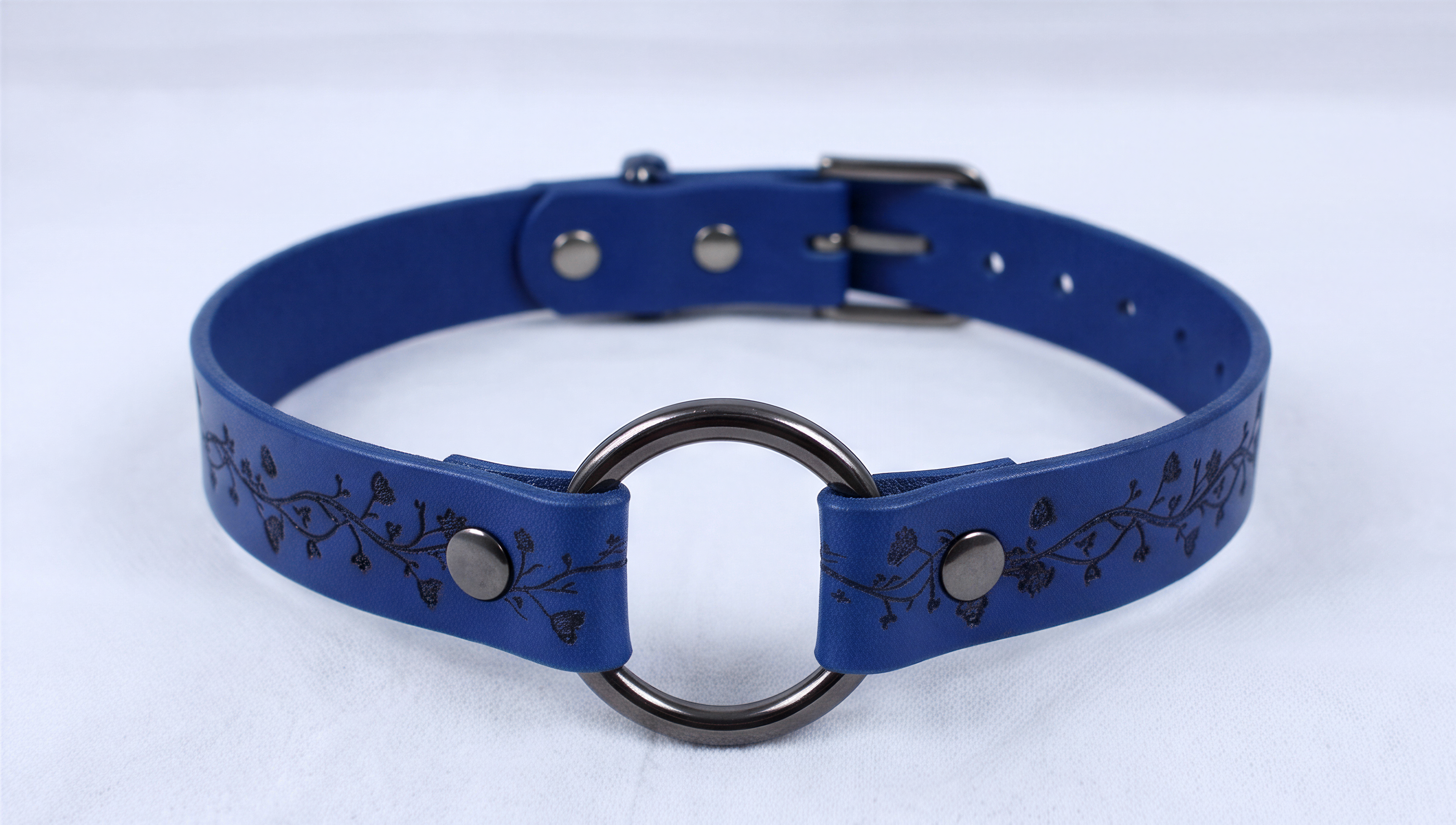 A blue leather choker collar with a metal ring and metal buckle.