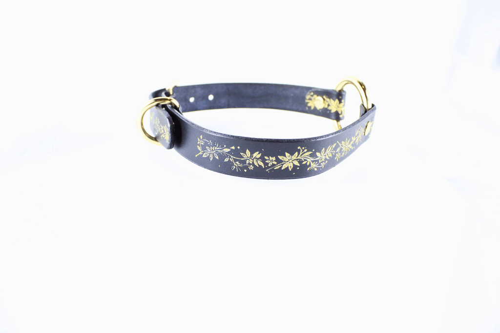 Black Leather Fetish Collar with golden floral pattern and polished O-ring for bondage or stylish wear.