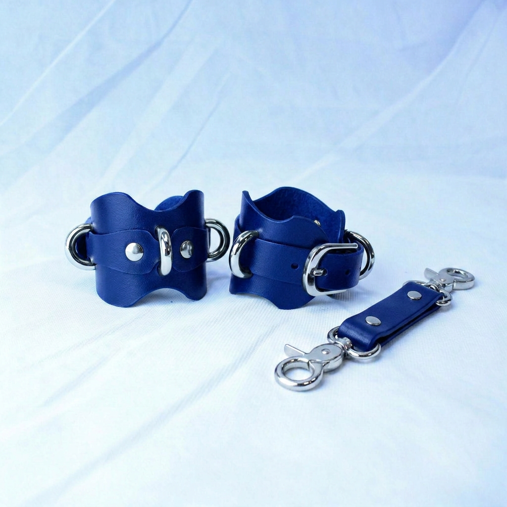 A pair of blue leather wrist straps with metal buckles and a metal clasp, along with a metal clasp, are displayed on a white background.