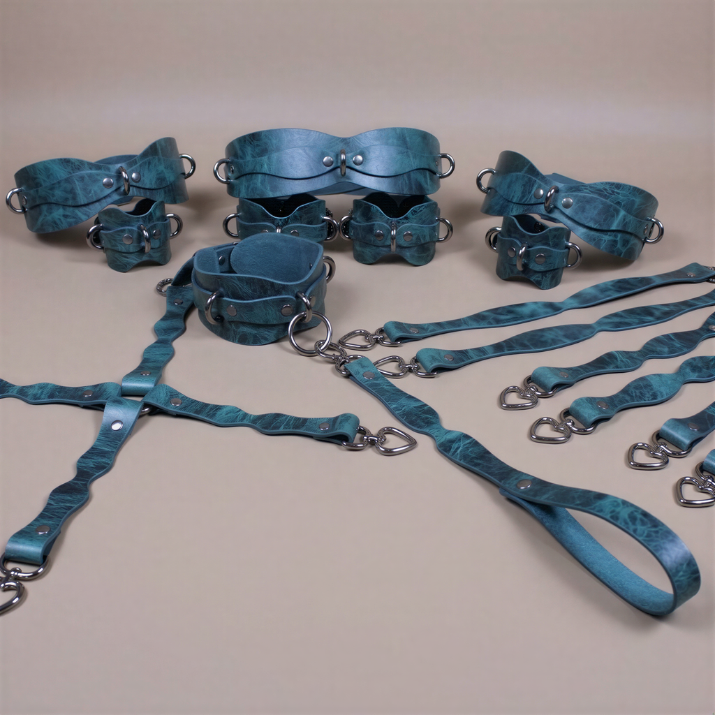 A collection of various leather straps and buckles in shades of blue and green, arranged on a beige background.