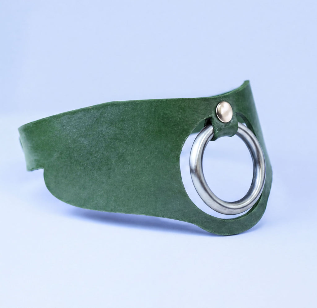 A green leather choker necklace with a silver metal ring on the front.