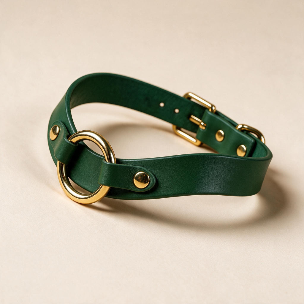 A green leather choker collar with gold metal studs and a gold-colored buckle.