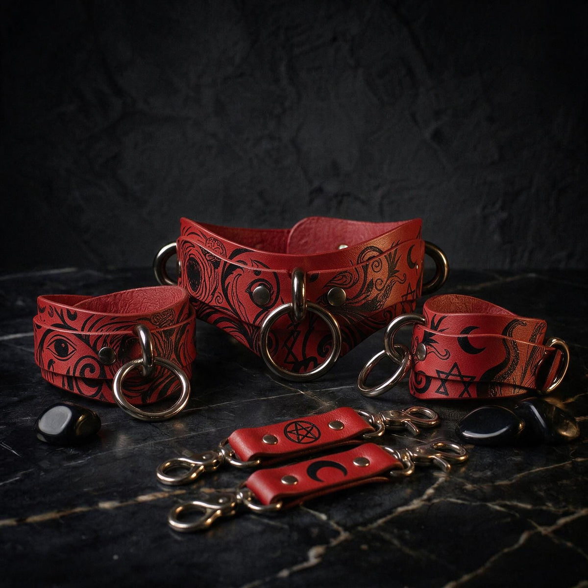 a collection of red leather straps with black designs, including skull and crossbones symbols, arranged on a dark surface.