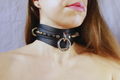 Obsidian BDSM Collar – Double Ring Submissive Choker Posture Collar featuring matte black leather and stainless-steel rings.