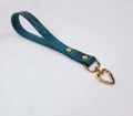 A blue leather strap with a heart-shaped metal clasp attached to it.