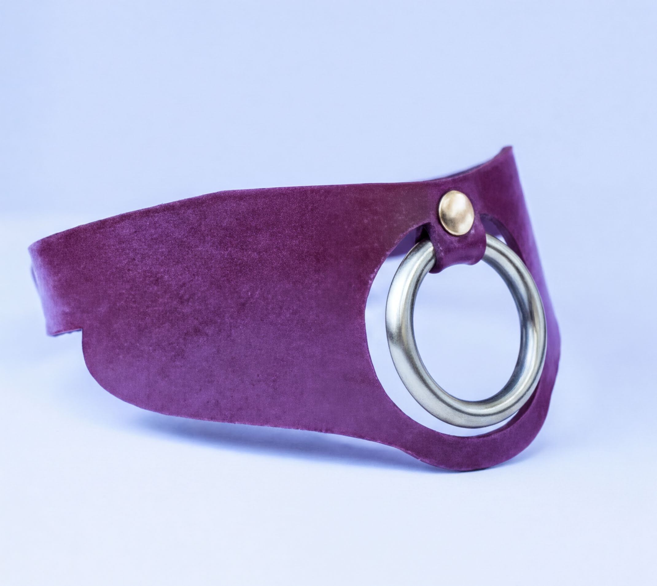 A purple leather choker necklace with a silver metal ring on the front.