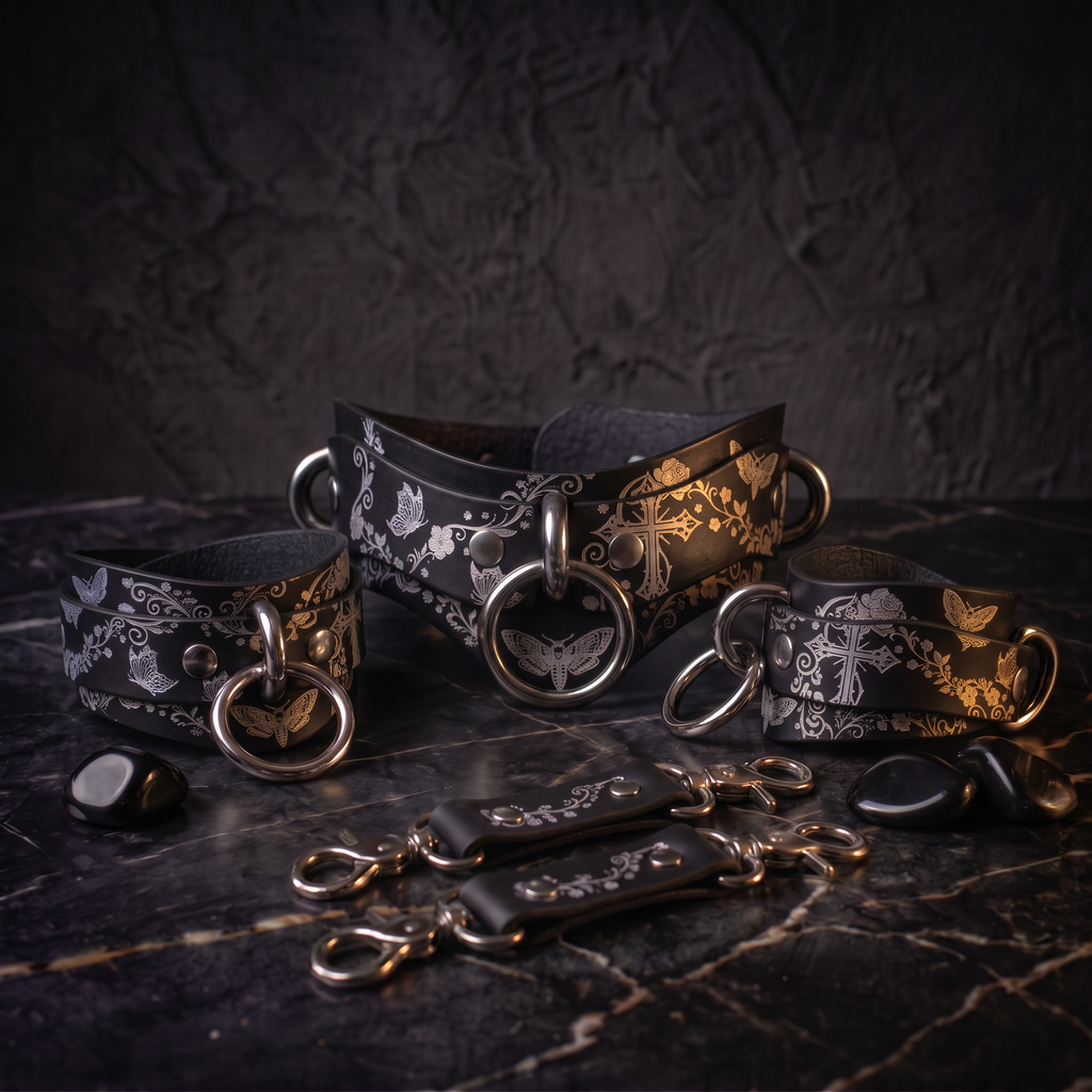 a collection of leather straps and buckles, each adorned with intricate floral designs, arranged on a dark surface.