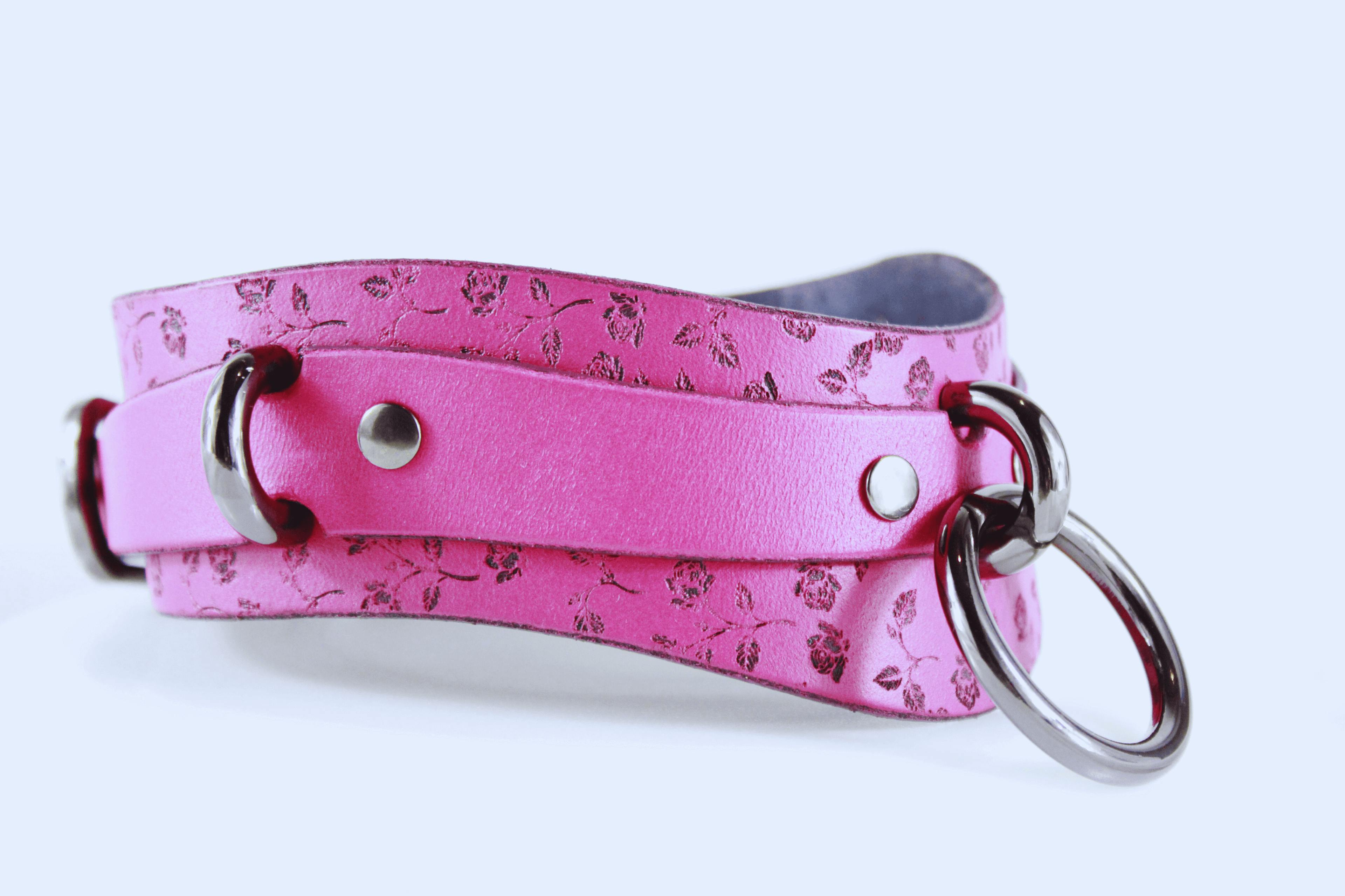 Rose Leather Submissive Collar with floral design and metal rings in soft pink leather.