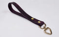 A purple leather strap with a heart-shaped metal clasp attached to it.