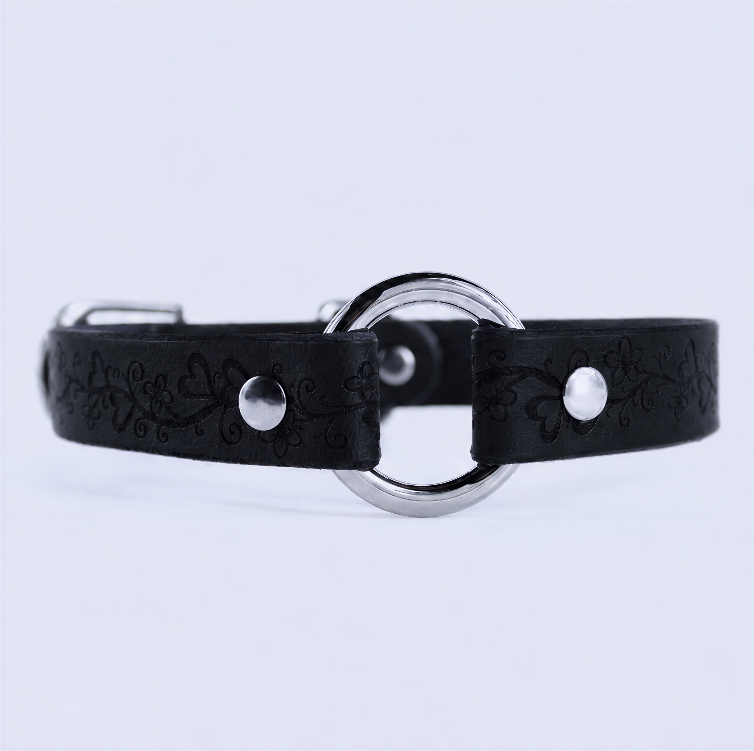 A black leather collar with a silver metal ring and two silver buttons.