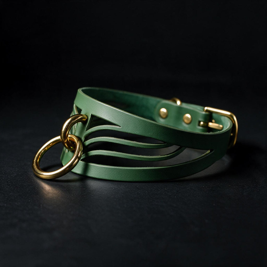 A green leather choker necklace with a gold-colored metal clasp and a unique, curved design.