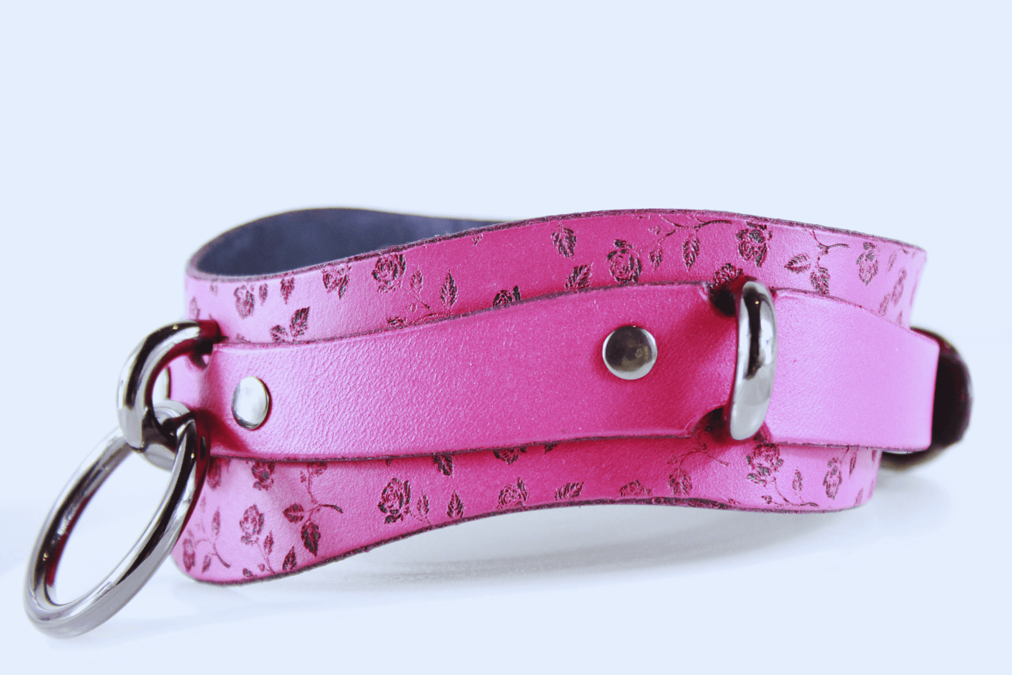 Rose Leather Submissive Collar in pink with floral patterns and metal accents, perfect for discreet day wear.