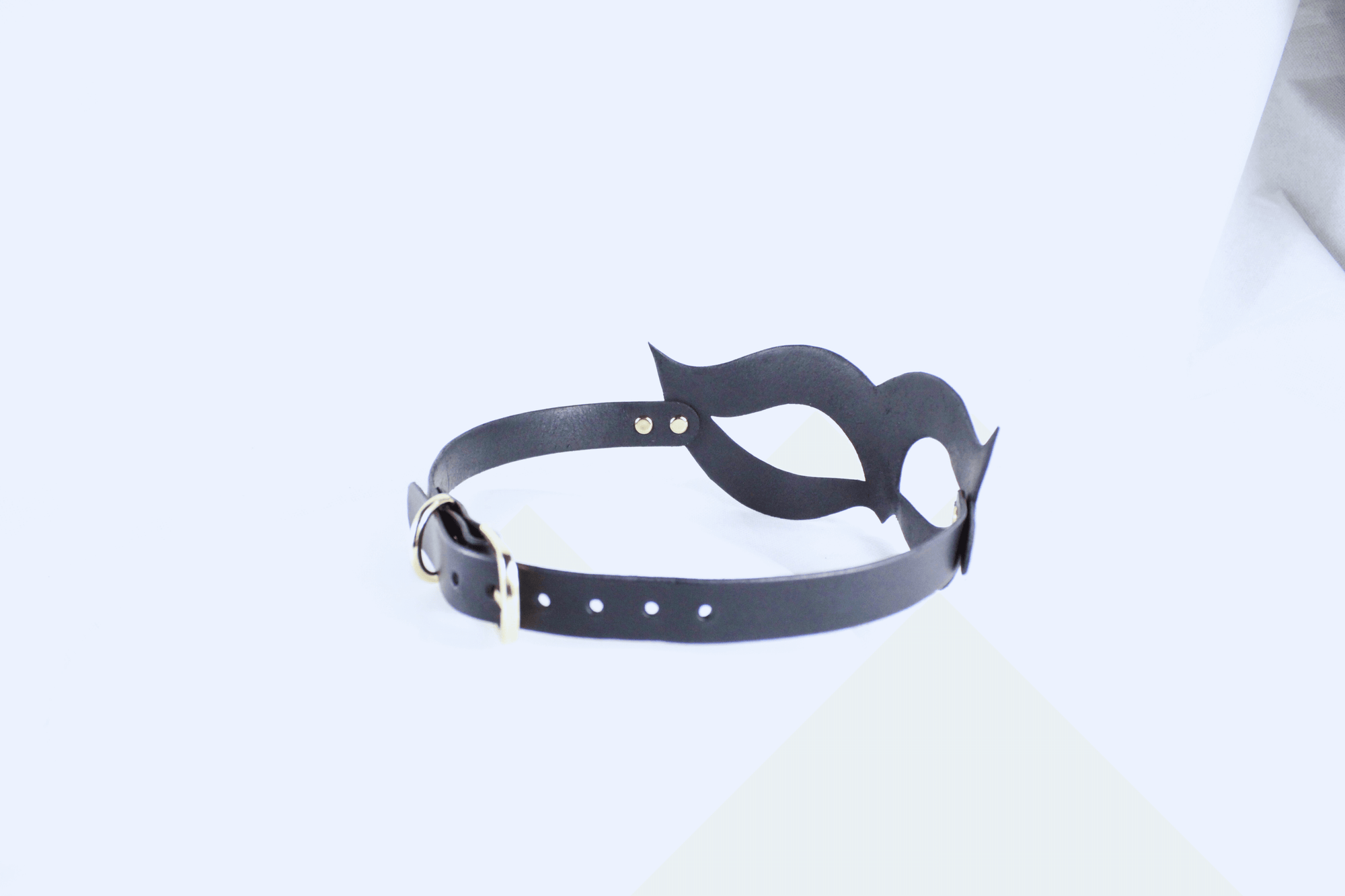 A black leather choker necklace with a unique, abstract design.