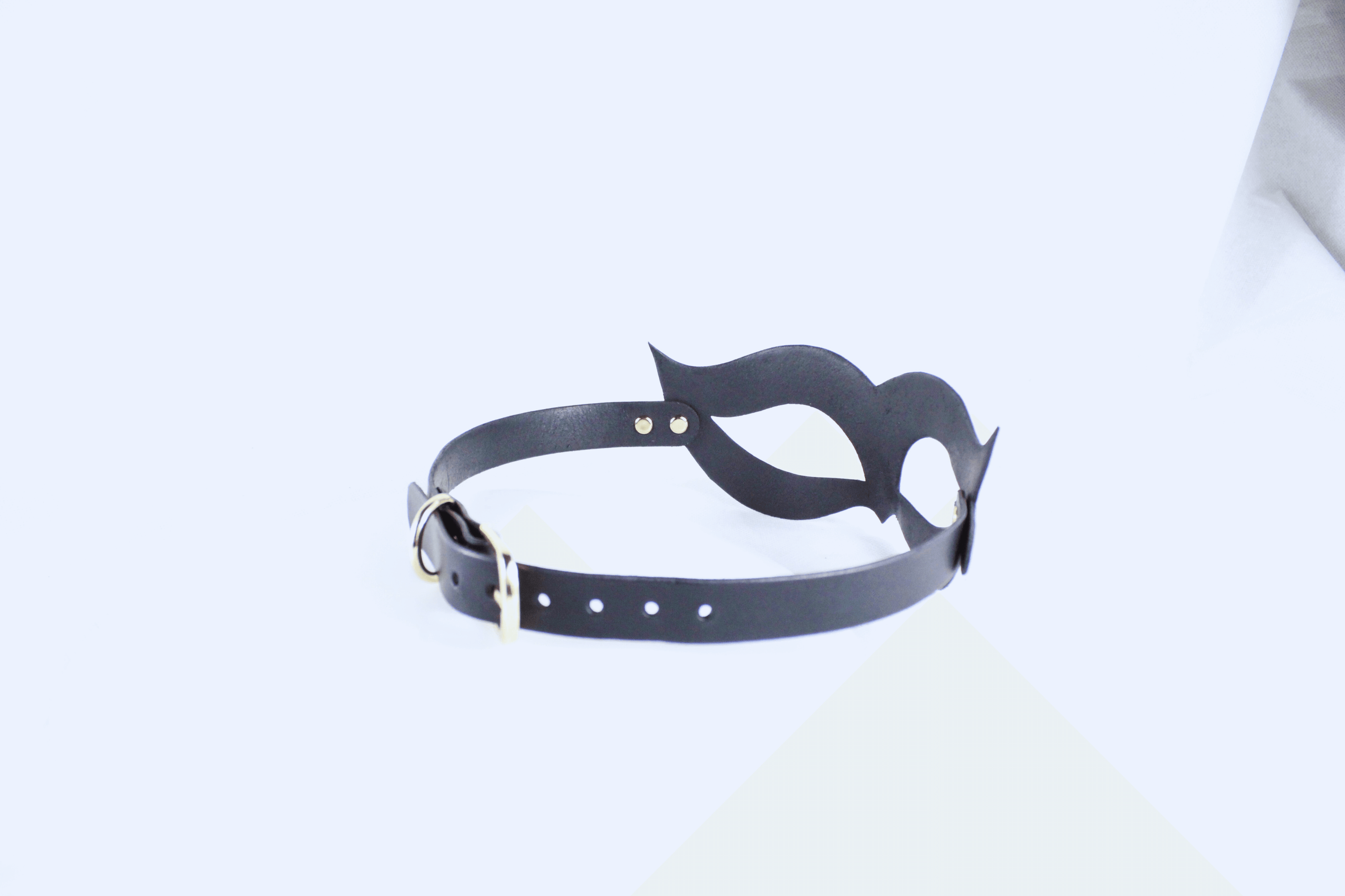 A black leather choker necklace with a unique, abstract design.