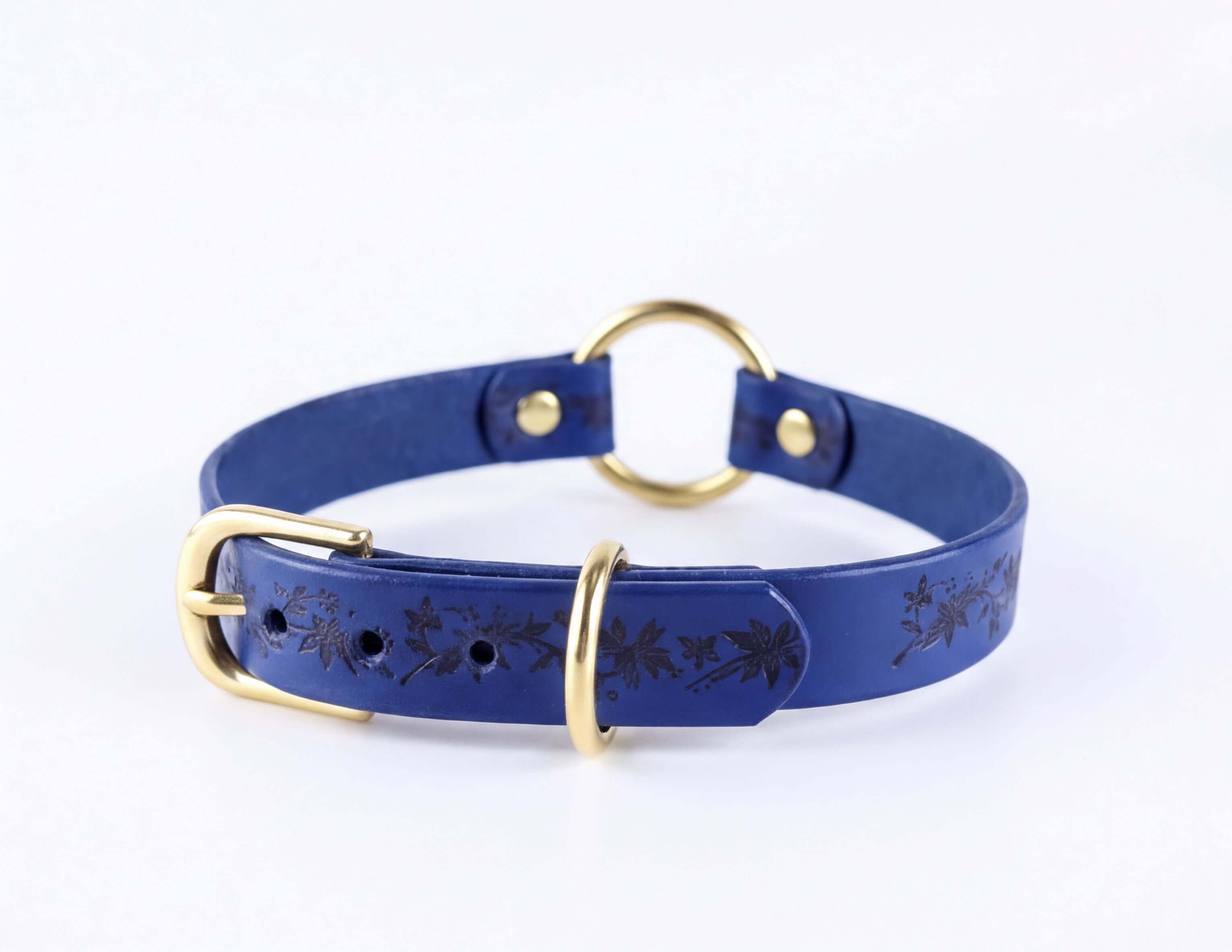 A blue leather choker collar with a gold-colored buckle and a floral pattern on the front.