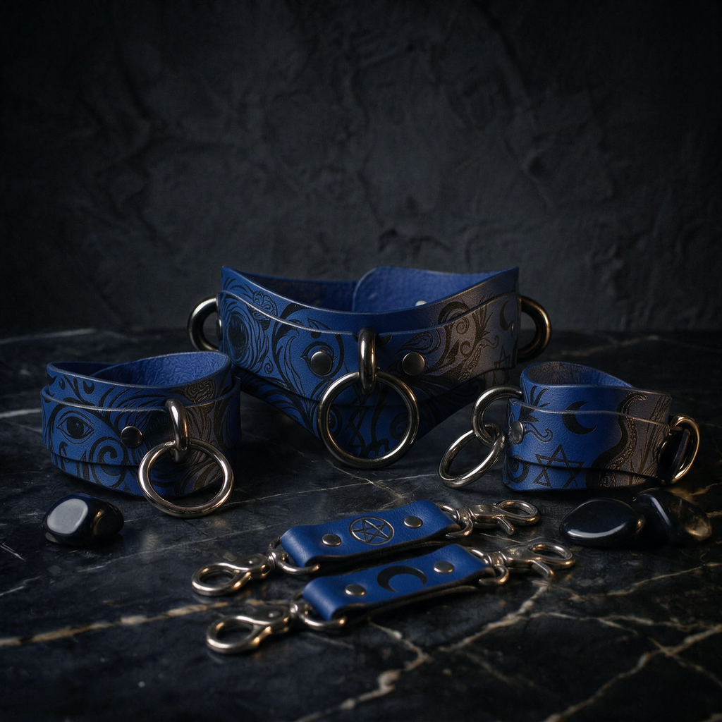 A collection of blue leather straps with metal rings and buckles, arranged on a dark surface.