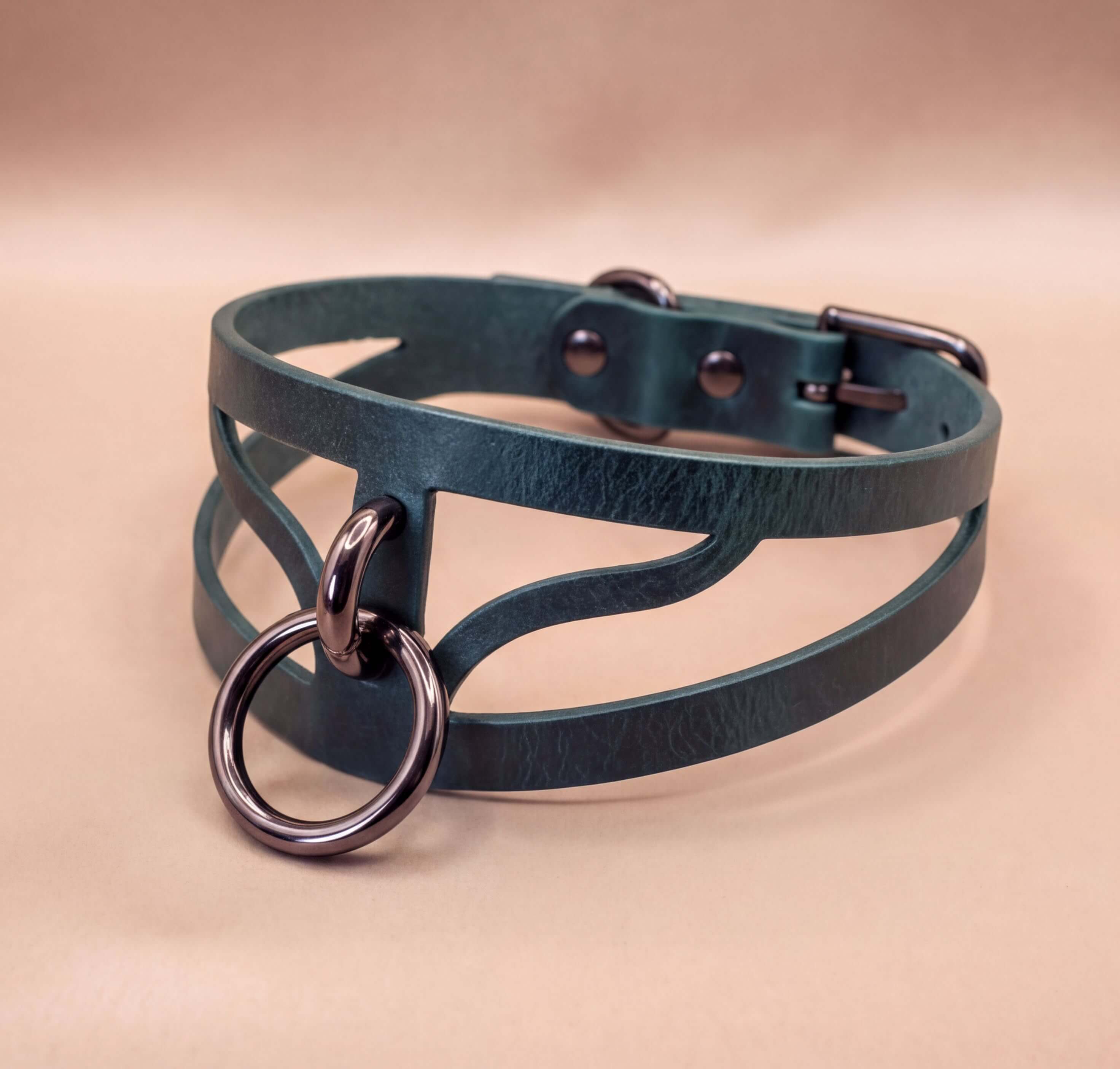 A dark green leather choker necklace with a metal ring and buckle.