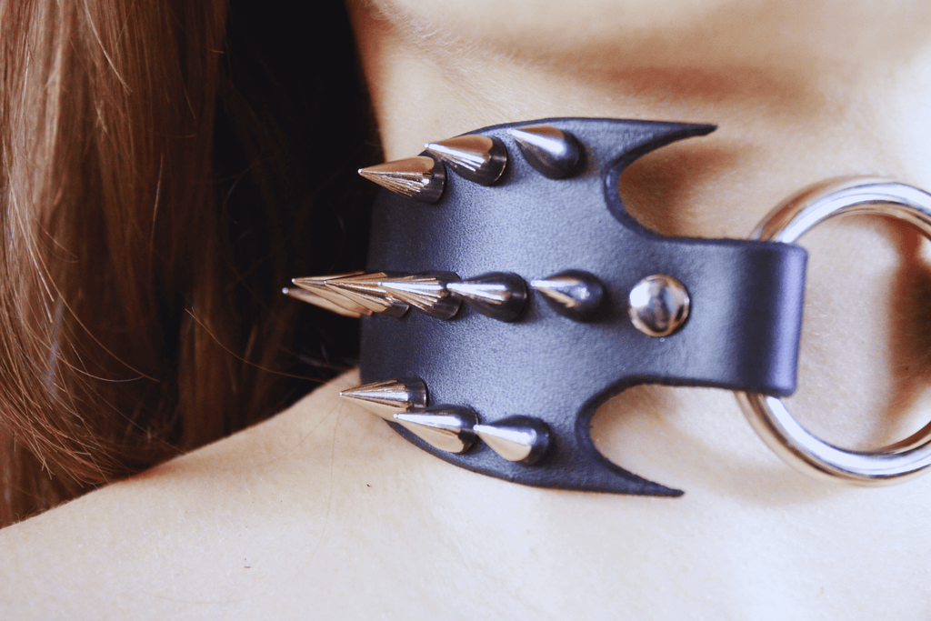 Close-up of Predator Leather Submissive Collar featuring spikes and a sleek design for BDSM enthusiasts.