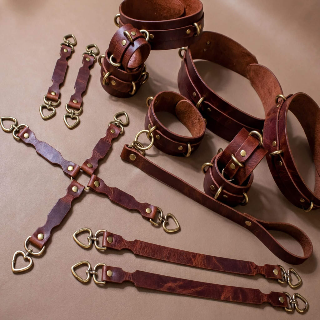 a collection of leather straps and buckles, likely used for securing or fastening items. The straps appear to be made of a dark brown leather material and are arranged in various positions, some overlapping each other. The image does not contain any text or specific details about the objects, and it does not provide any information about the context or purpose of the straps.