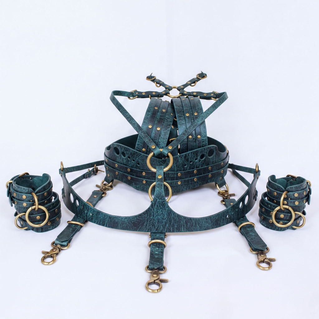 A set of dark green leather straps with gold-colored buckles and clasps, arranged in a circular pattern.