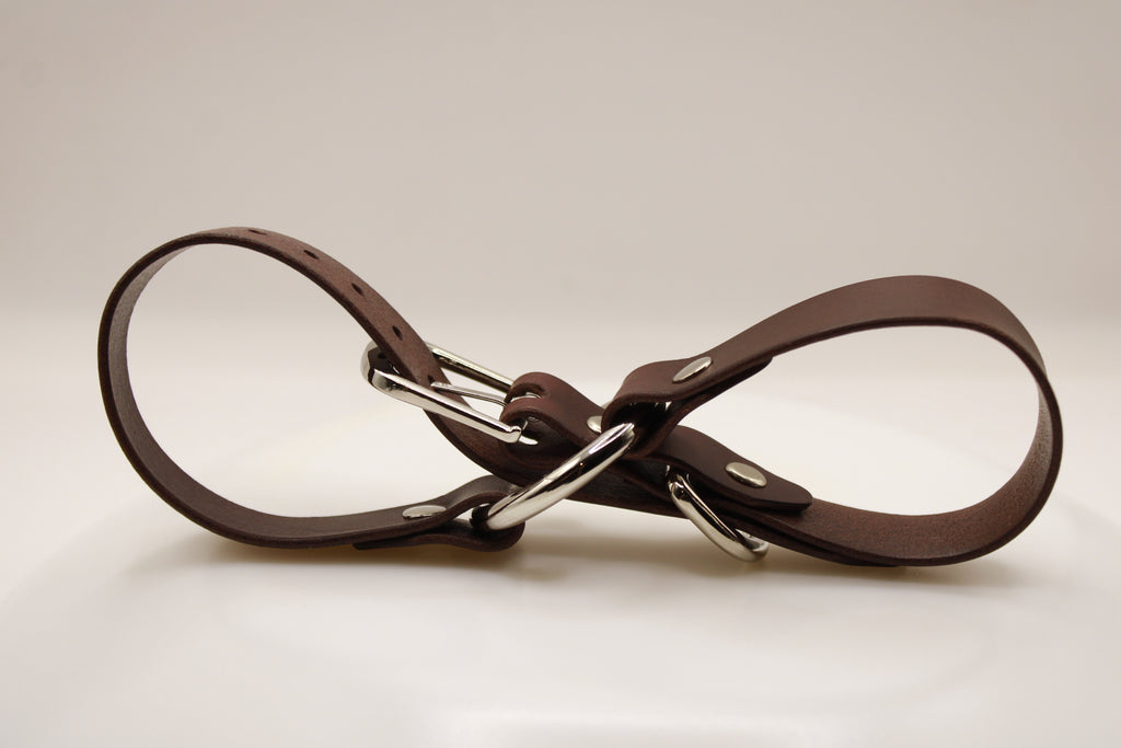 A brown leather belt with silver buckles is shown in the image.